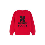 A bright red crewneck sweatshirt featuring a black geometric logo and the text 'THE NEW SOCIETY' printed on the chest, displayed against a clean white background.